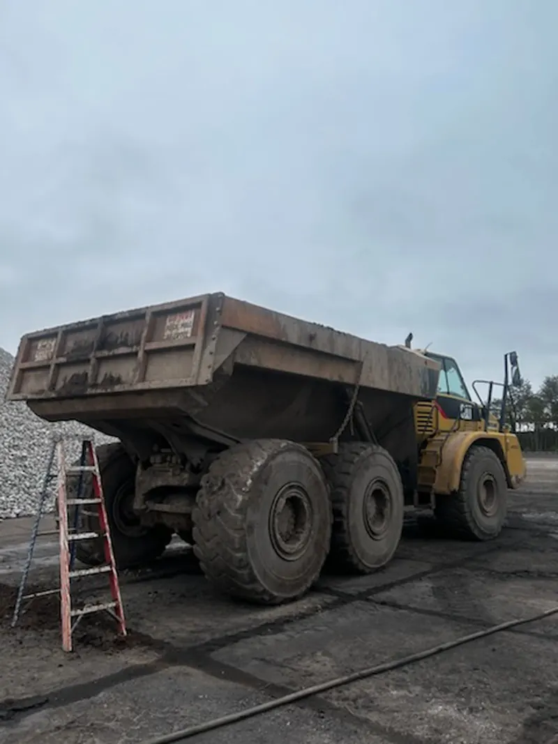 Articulated haul truck, bed and tires before