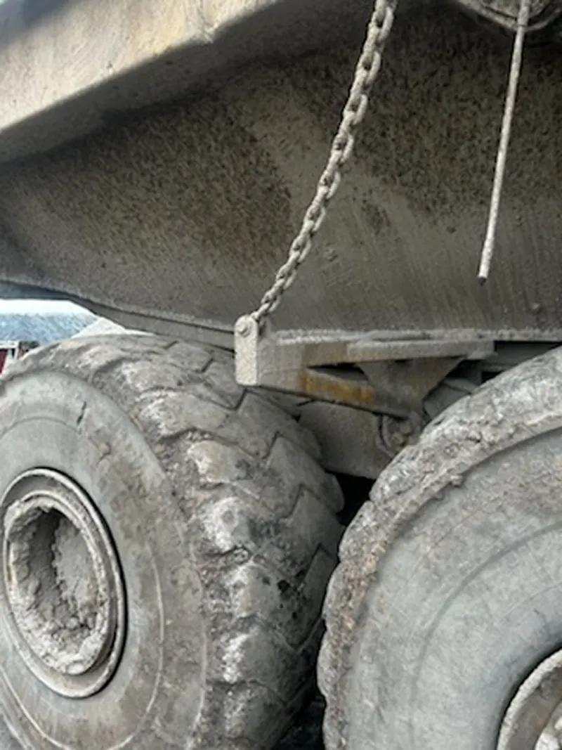 Packed mud and salt on the tires and underbody of a haul truck